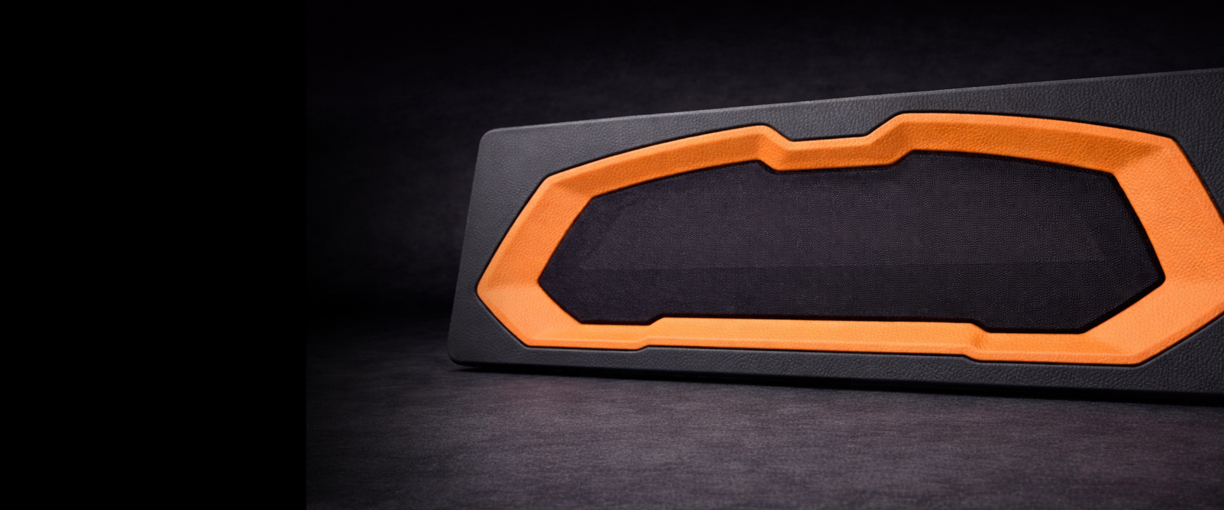 Black and orange geometric object on a dark background